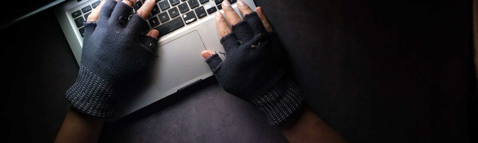 https://www.pexels.com/photo/a-person-typing-on-laptop-while-wearing-a-fingerless-gloves-8541751/